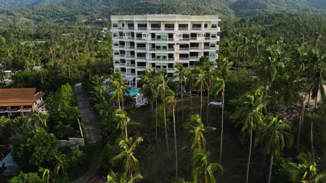 huge resort hotel between palm trees in tropical paradise