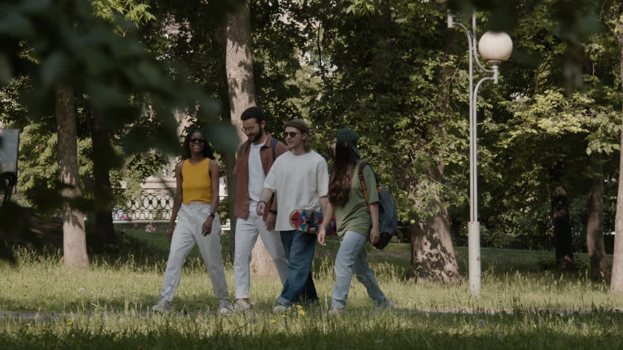 Group of Young Adults Walking in a Park on a Sunny Day