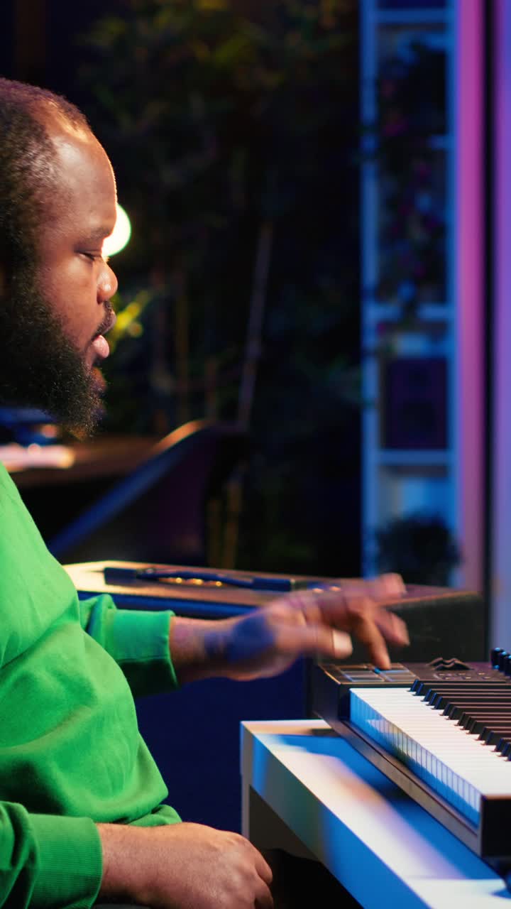 African American Man Playing Digital Piano in Home Music Studio