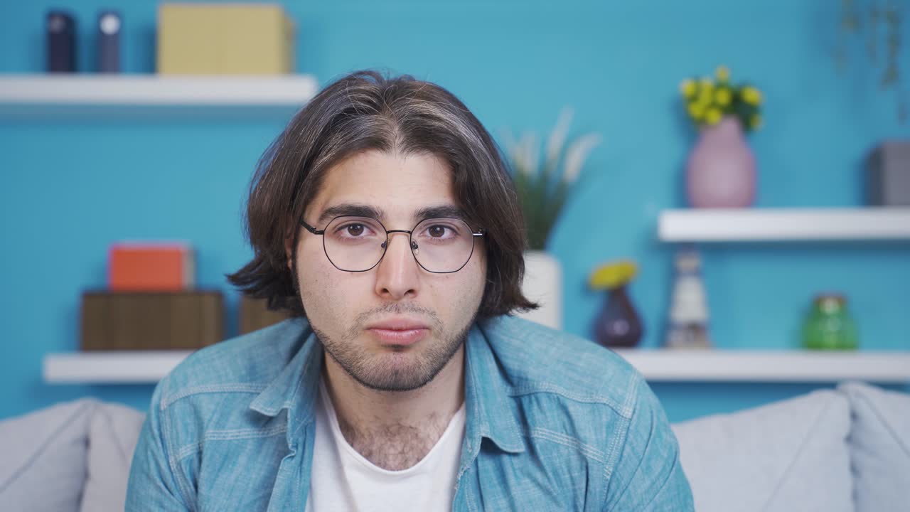 Young man looking at camera with wonder and amazement. Listening to news and announcements.