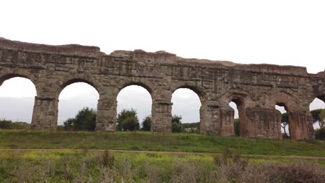 Detail-of-an-aqueduct-from-ancient-Rome-in-parco-degli-acquedotti-in-the-outskirts-of-the-capital-of-Italy,-dolly-movement-side-ways