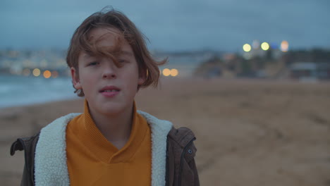 Teenage-Boy-Looking-at-Camera-by-the-Ocean