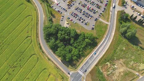 Aerial-view-of-the-logistics-park-with-warehouse,-loading-hub-and-many-semi-trucks-with-cargo-trailers-standing-at-the-ramps-for-load-unload-goods-at-sunset