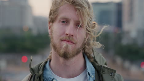 portrait attractive young student man turns head looking confident independent male enjoying urban lifestyle in city at sunset wind blowing hair real people series