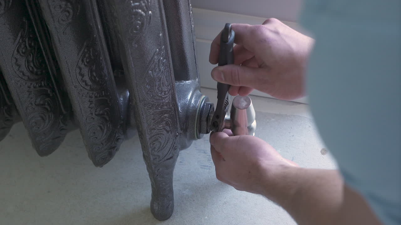A radiator is fixed using a spanner in a new home