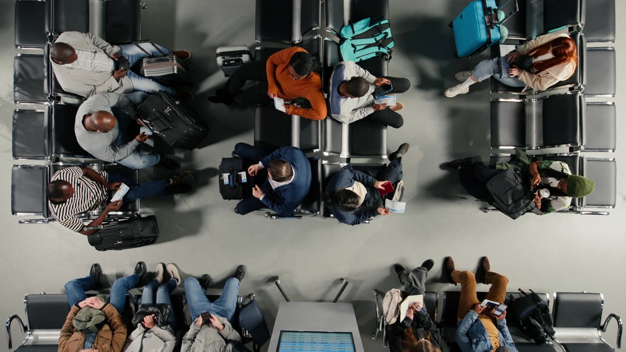 Going to boarding gate, wheeled luggage and multiethnic travelers in airport
