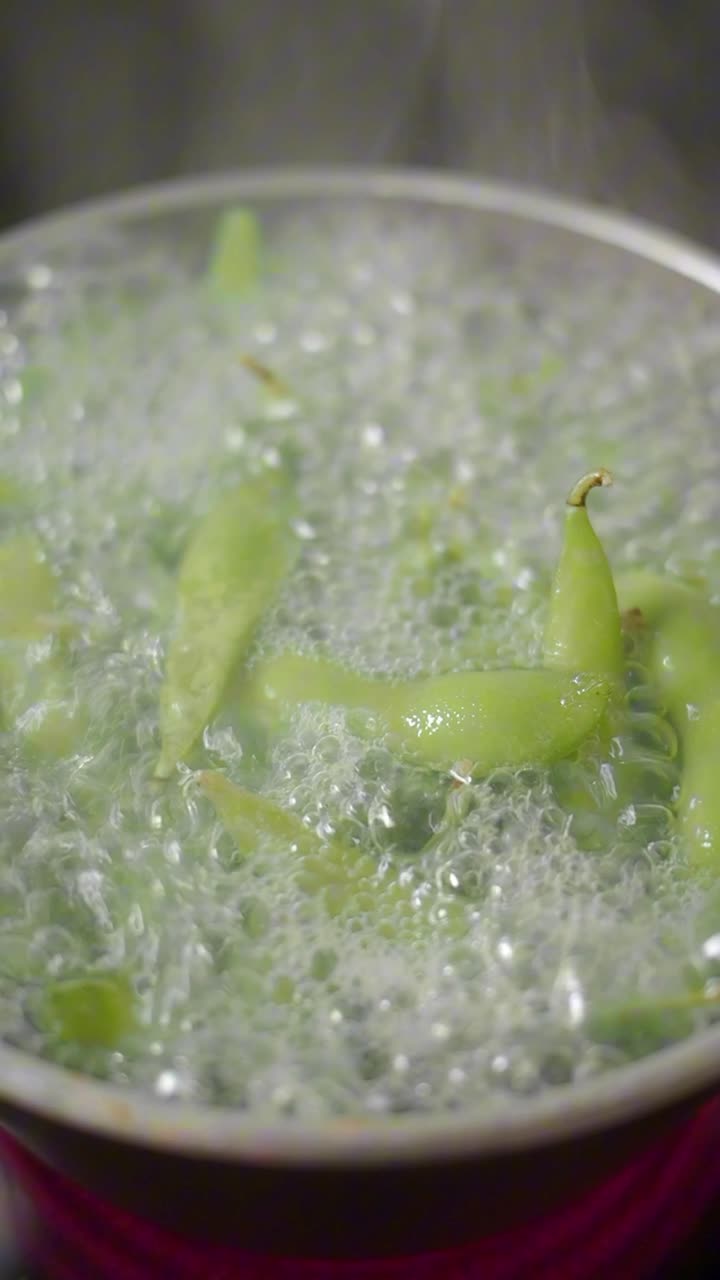 Green Pods Boiling in a Pot with Steam