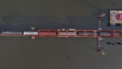 Birds-eye-view-of-train-traveling-over-the-Calcasieu-River-in-Lake-Charles,-Louisiana