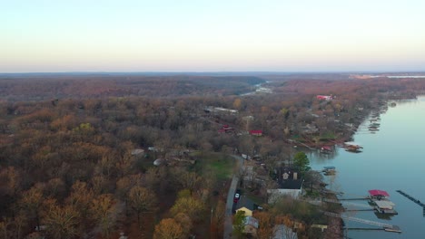 Lake-House-Vacation-Home-Reveal-With-Driveway-and-Boats-At-Grand-Lake-In-Midwest-Oklahoma-With-Forest-And-Fishing-Docks---aerial-drone-descending