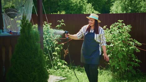 woman watering plants in her garden