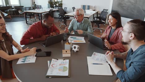 diverse group of colleagues having meeting in office