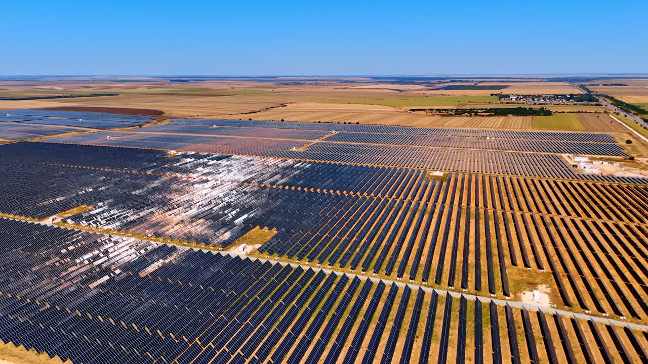 Vast solar panels in fields. Solar panels in a rural area capture sunlight, highlighting renewable energy production under a clear sky