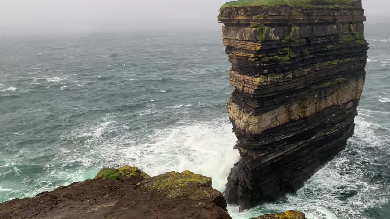 Static shot of Downpatrick Head with stormy sea