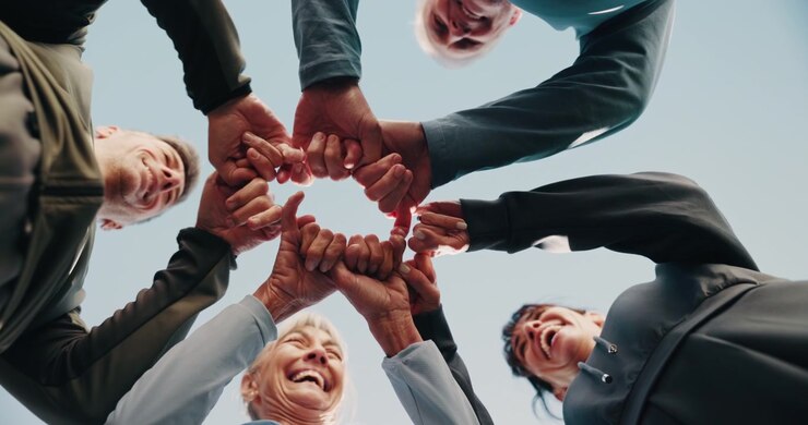 Diverse Group of People Joining Fists Together in Unity