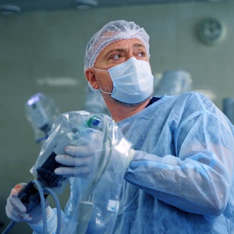 doctor in the operating room. surgeon conduct a surgery with modern equipment. portrait of a doctor in mask with robotic arm. new technologies in medicine.