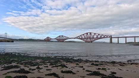 forth bridge and beach in edinburgh, scotland