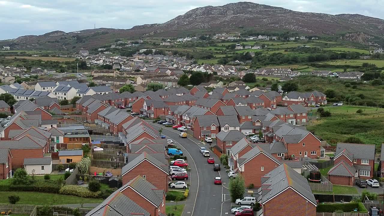 Welsh townhouse modern property aerial view flying across the rocky mountain neighbourhood