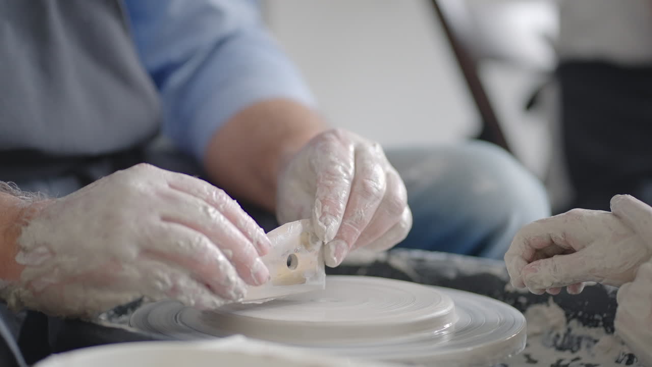 Close-up of a male master working on a potter's wheel close-up in slow motion