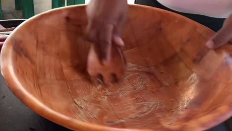 hands of a latin american person preparing the caesar dressing, top down shot