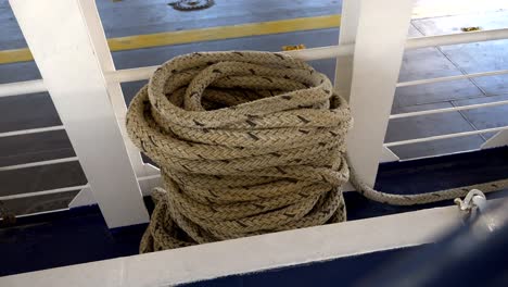 Thick-coiled-rope-lying-on-the-ferry's-deck