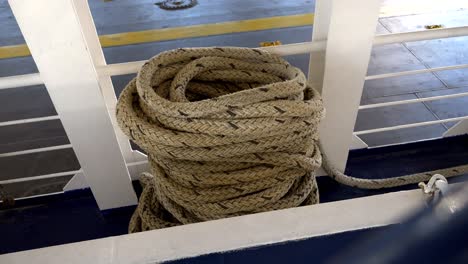 Thick coiled rope lying on the ferry&#039;s deck