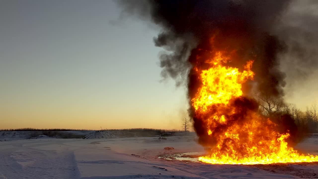 Huge blazing oil fire sends massive amounts of thick black smoke into the atmosphere