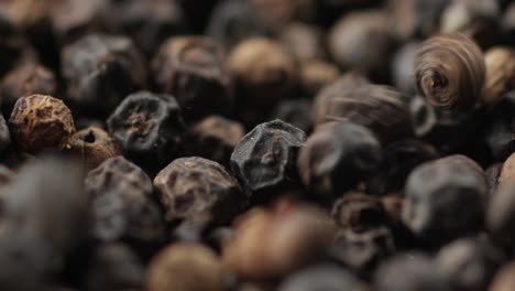 Dried-Black-Peppercorns-Falling,-Extreme-Close-Up-Of-Pepper-Spice-Seeds