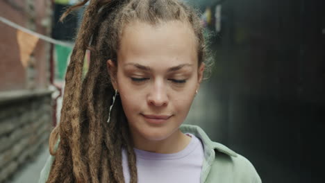 young woman with dreadlocks in an urban setting