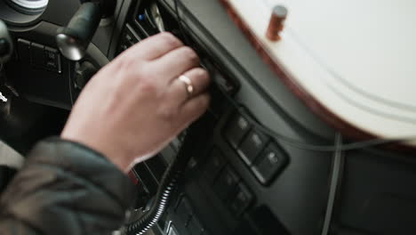 man setting up the radio on a truck