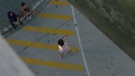 dancing woman young street dancer with afro performing contemporary moves friends watching enjoying urban freestyle dance in city overhead view