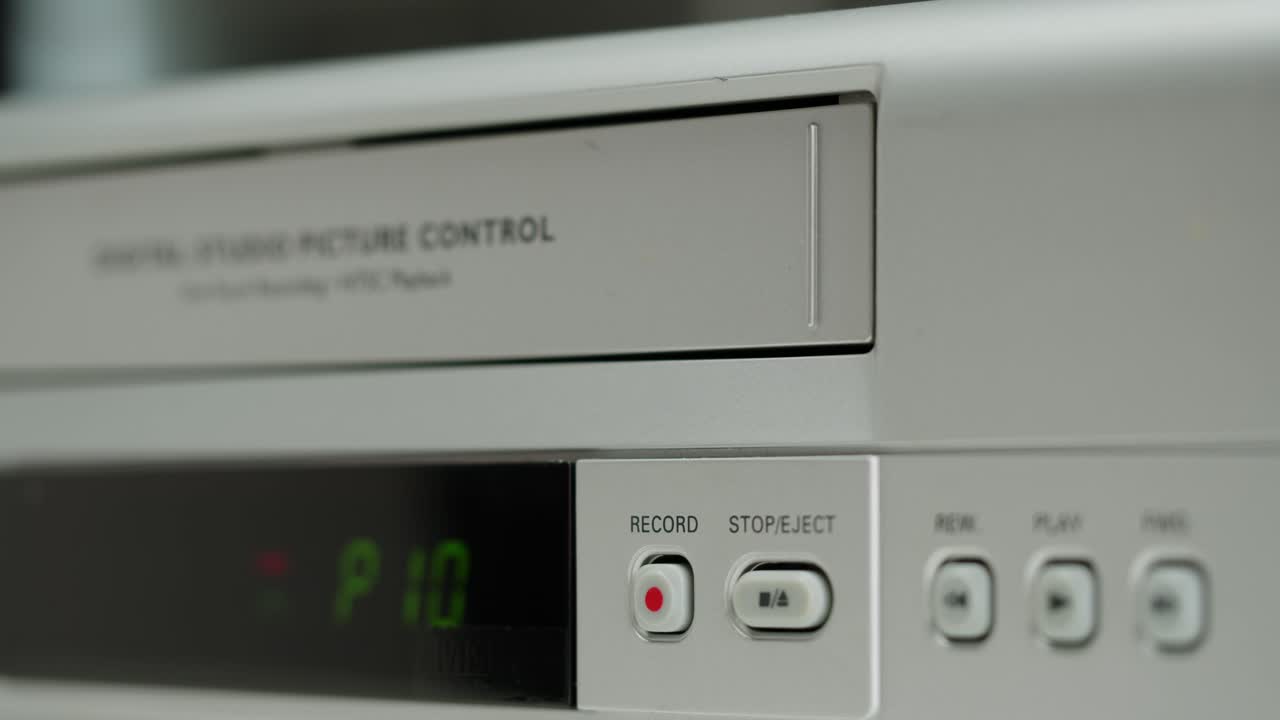 Vintage VCR with Tape Being Inserted