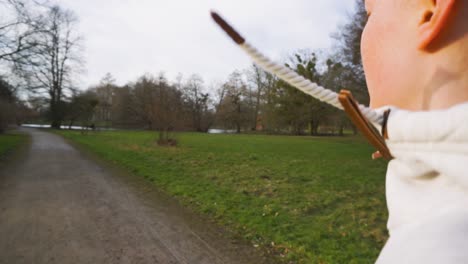 active young female with long ponytail jogs through a park