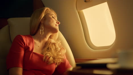 aircraft passenger travel first class closeup. tired beautiful blonde dreaming