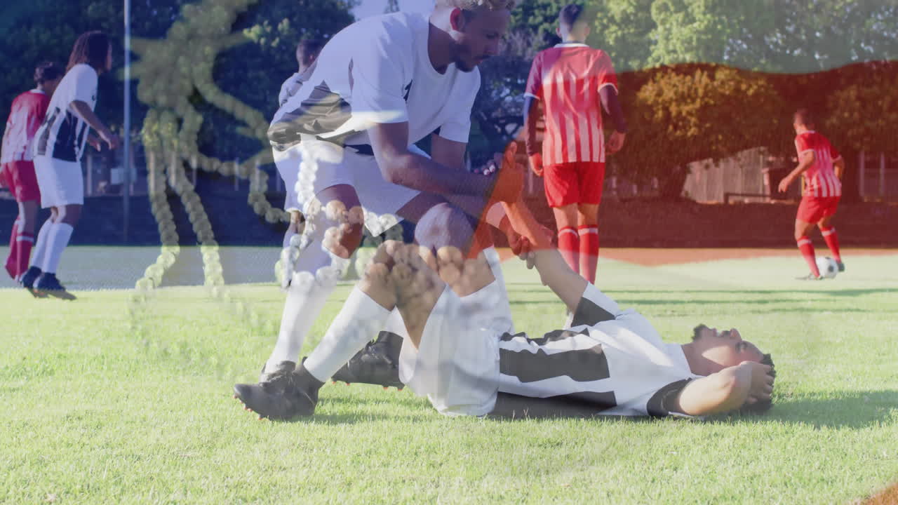 Soccer player helping injured teammate on field with DNA strand animation overlay