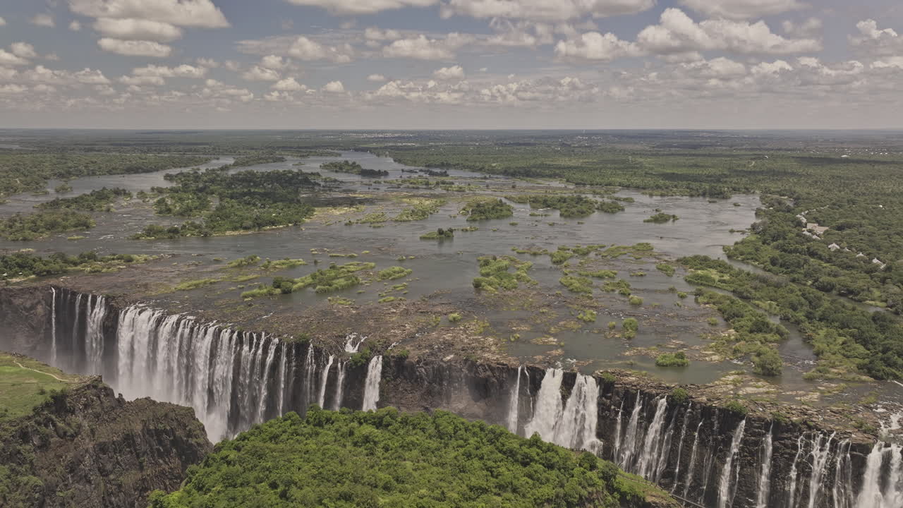Victoria Falls Zimbabwe Aerial v15 flyover Zambezi River capturing the majestic cataract waterfall thundering over the cliffs, nature's untouched beauty - Shot with Mavic 3 Pro Cine - Jan 3rd 2024