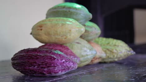 Detail-of-different-types-of-cocoa-fruits-on-a-wooden-table