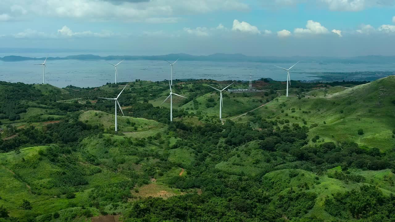 Aerial View of Wind Turbines on Lush Green Hills