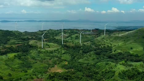 Aerial View of Wind Turbines on Lush Green Hills
