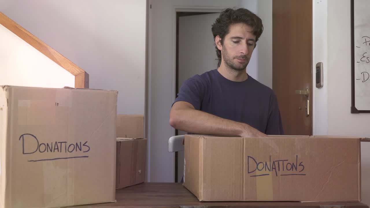 Man Packing Canned Goods into Donation Boxes