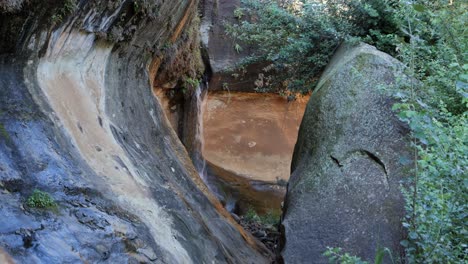 Eons-of-water-flow-erodes-ancient-sandstone-cliff-into-smooth-shapes