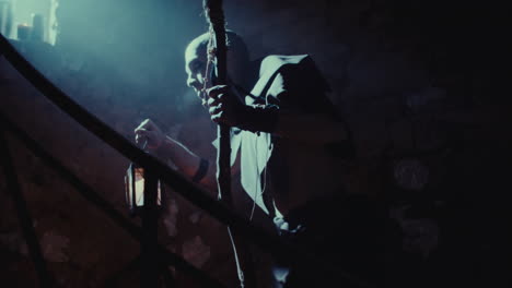 a man with a lantern in a dungeon