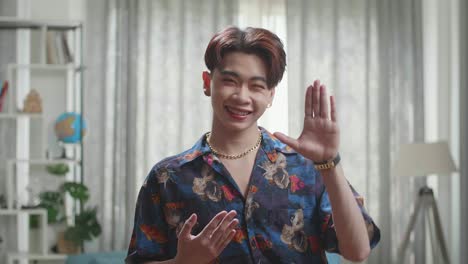 asian transgender male dancing while shooting video content for social networks at home