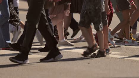 the feet of people at the crosswalk.