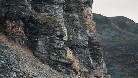 dark crumbling rocks towering above the vast valley