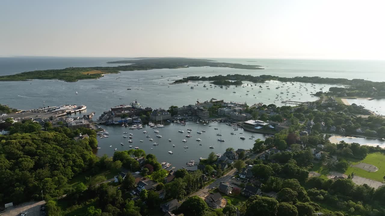 Drone shot of Cape Cod's lush green land intermixing with the surrounding ocean