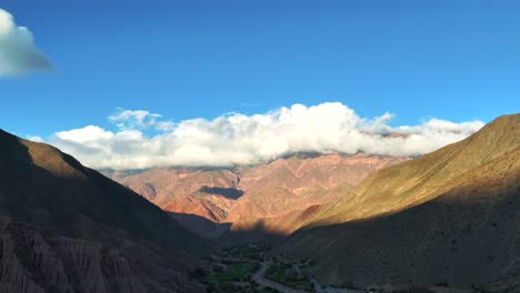 beautiful mountain range with clouds resting on its peaks, near purmamarca in jujuy, northeastern argentina