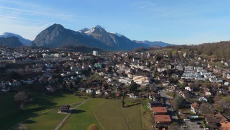 spiez, switzerland with swiss alps in the background, clear sky, daylight, aerial view