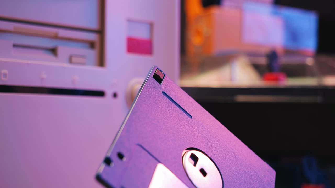 Using diskette for old computer. Music recorder, playing retro computer games. Vintage device for office, obsolete technology. . High quality 4k footage