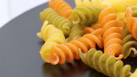 Close-up-view-of-fusilli,-italian-colored-macaroni,-macro-shot-in-4k