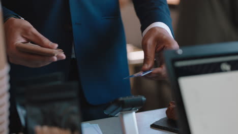 attractive businessman paying using credit card transaction buying coffee in cafe happy customer enjoying service spending money at restaurant